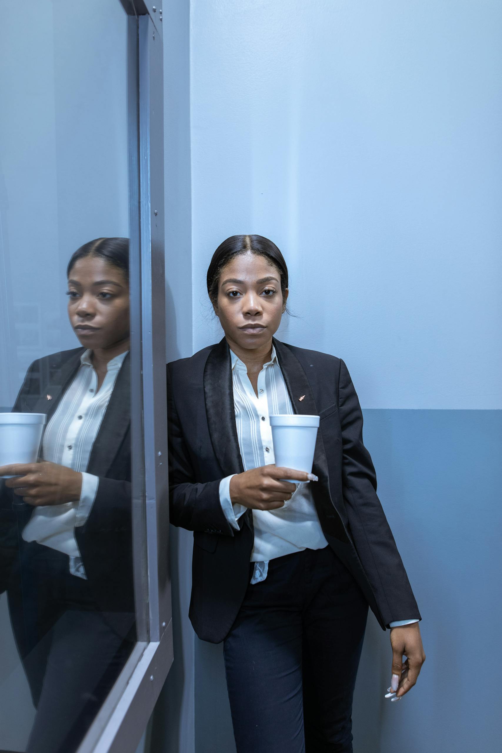 Man in Black Suit Standing Beside Woman in Black Blazer