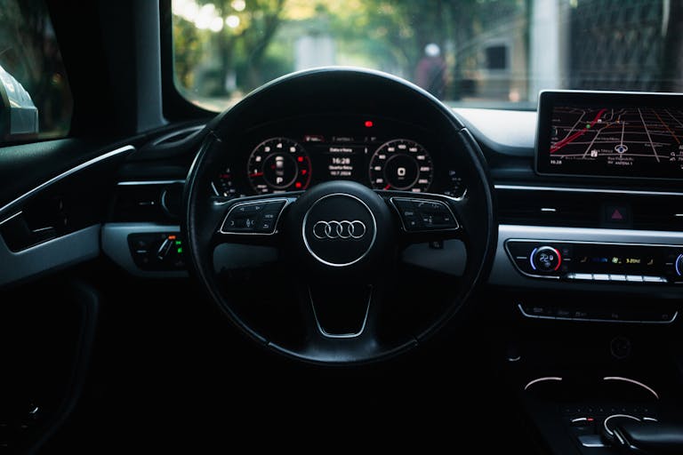 The dashboard of an audi car with the steering wheel