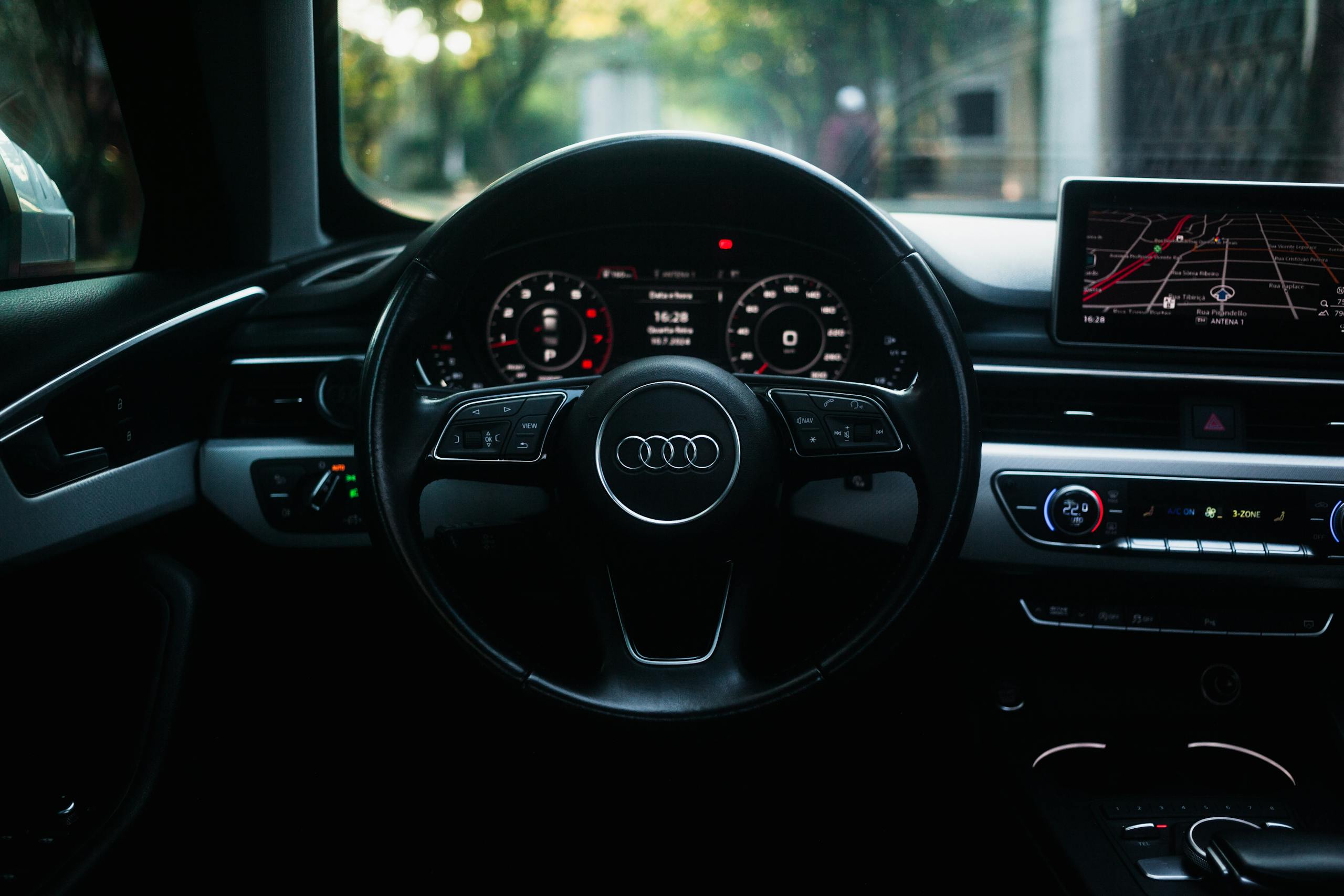 The dashboard of an audi car with the steering wheel