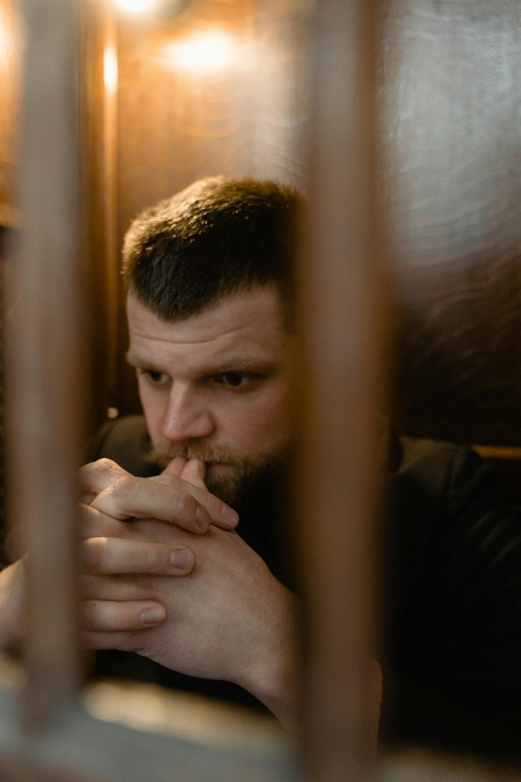 Photograph of a Man Praying with His Hands Together