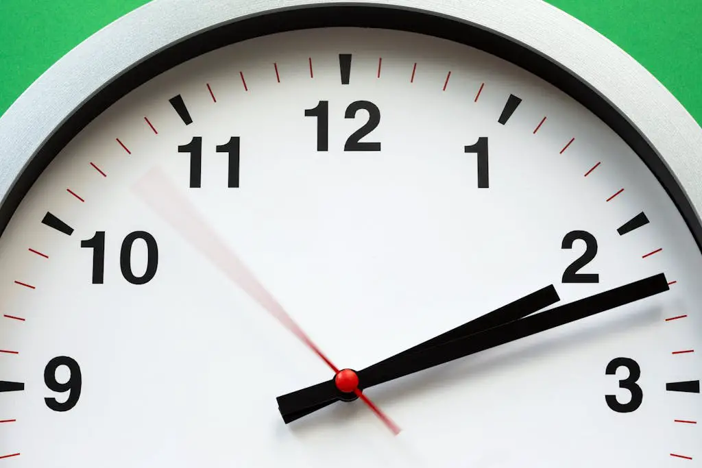 A close-up image of an analog clock face showing time with blurred motion